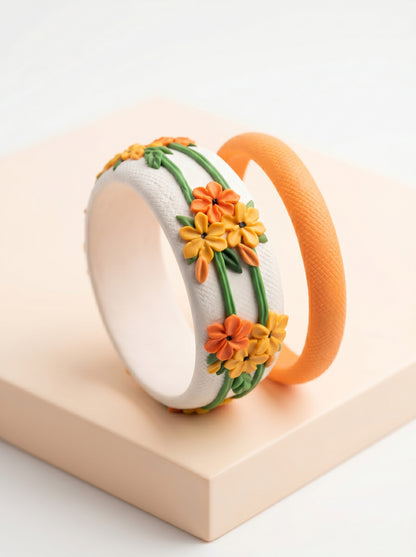 Two floral-patterned bracelets on a beige surface